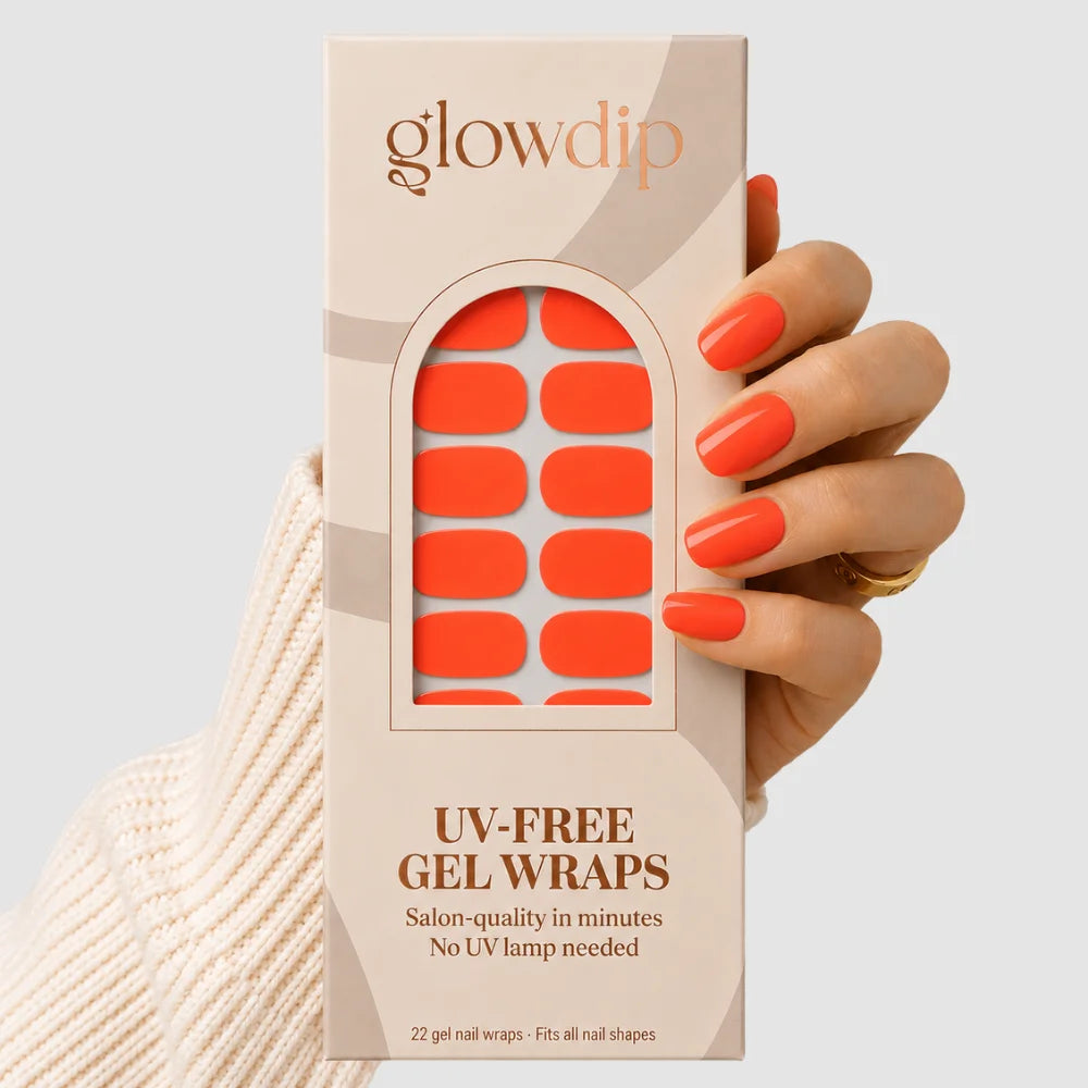 Een hand houdt een doos glowdip uv-vrije gel nagelwraps met oranje rechthoekige stickers coral crush
