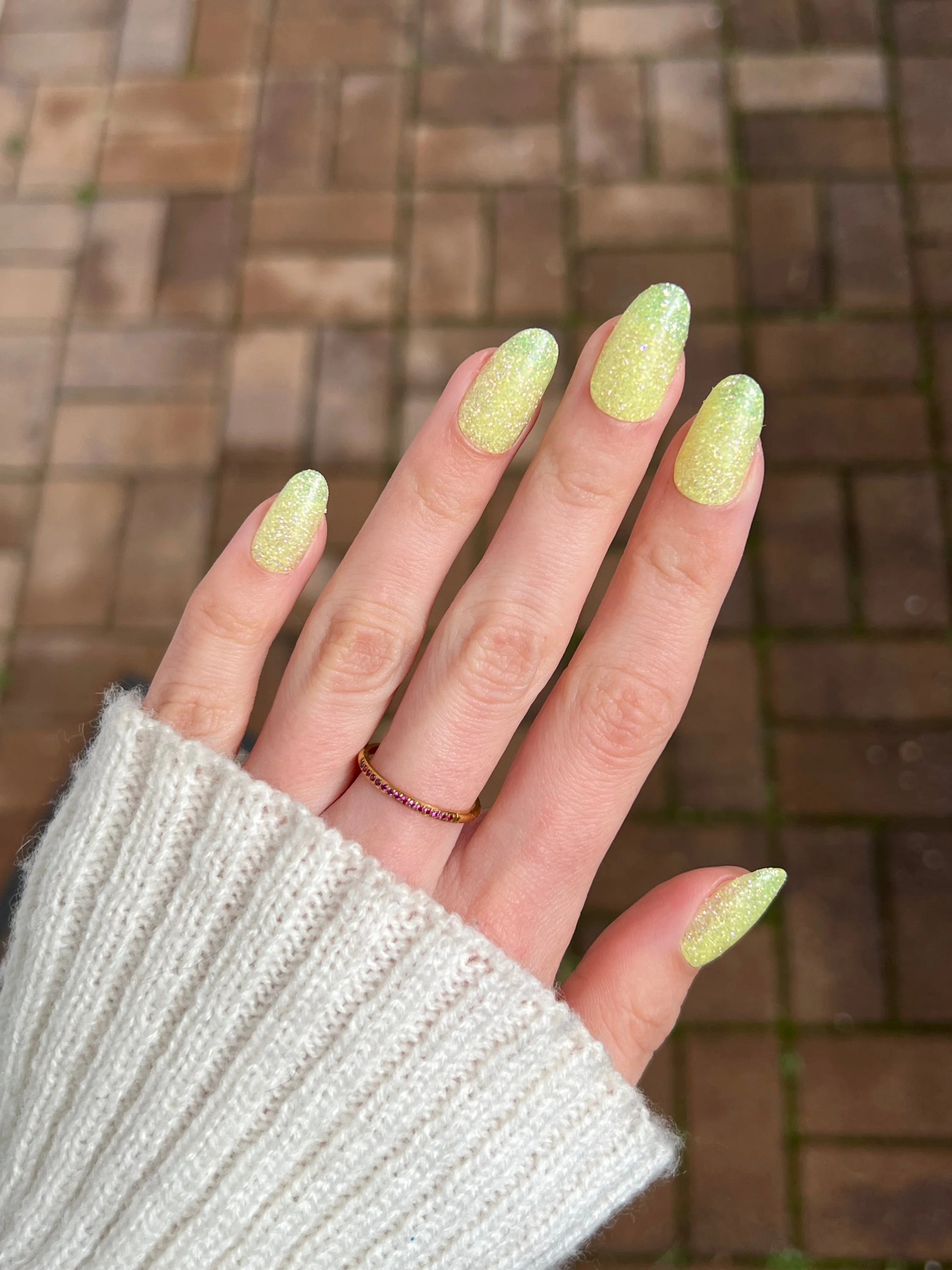 Lange amandelvormige nagels gelakt met glinsterende lichtgele lemon fizz dipping powder nagellak